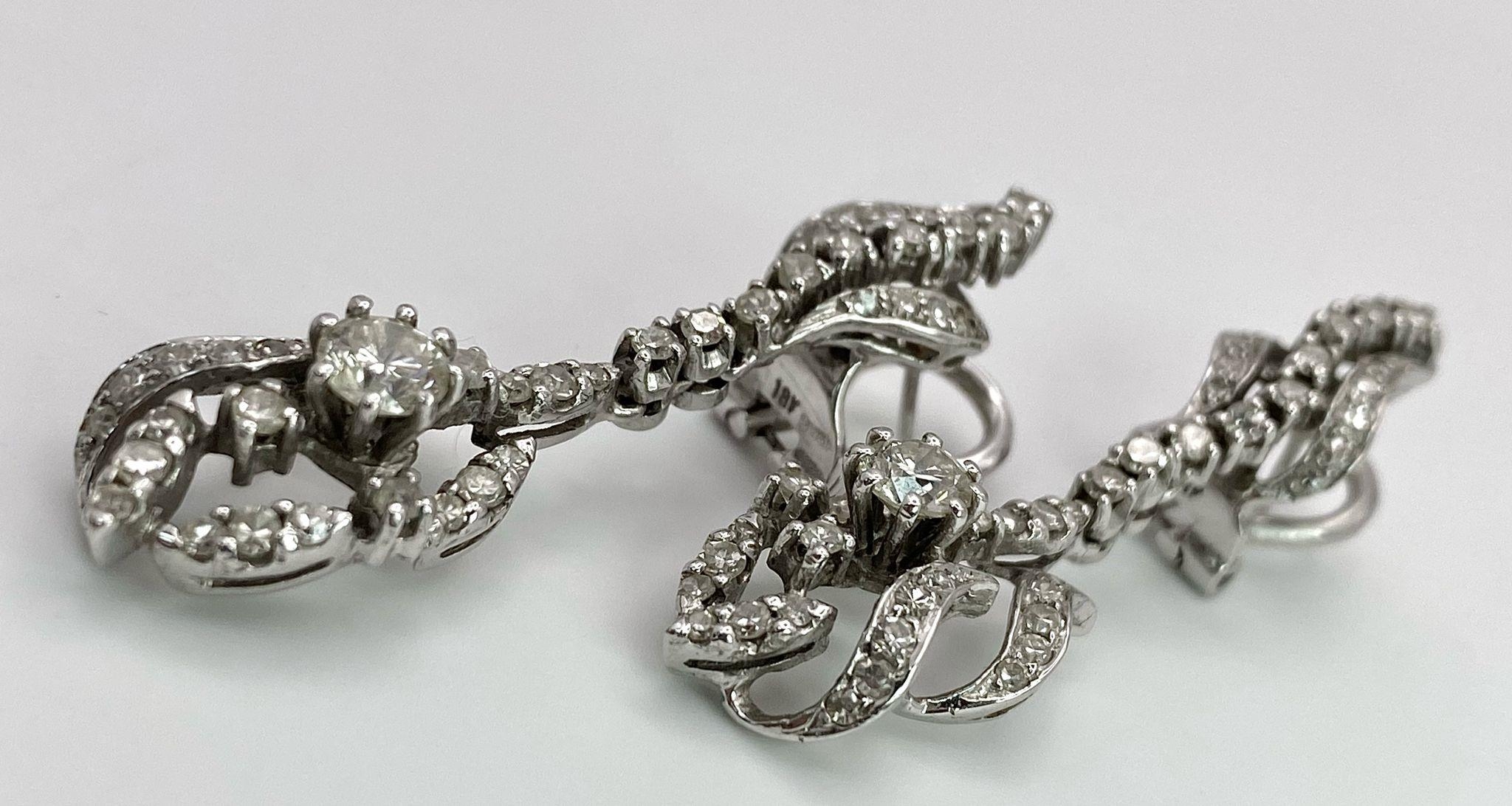 A Pair of Art Deco Style 18K White Gold and Diamond Drop Earrings. An array of round and brilliant - Image 2 of 15