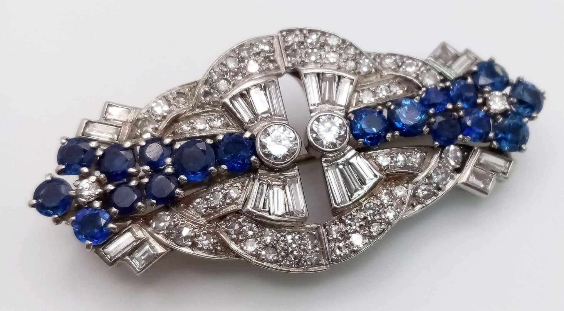 A Glamourous 9K White Gold Art Deco Style Double Clip Brooch. 4ctw of different cut quality diamonds