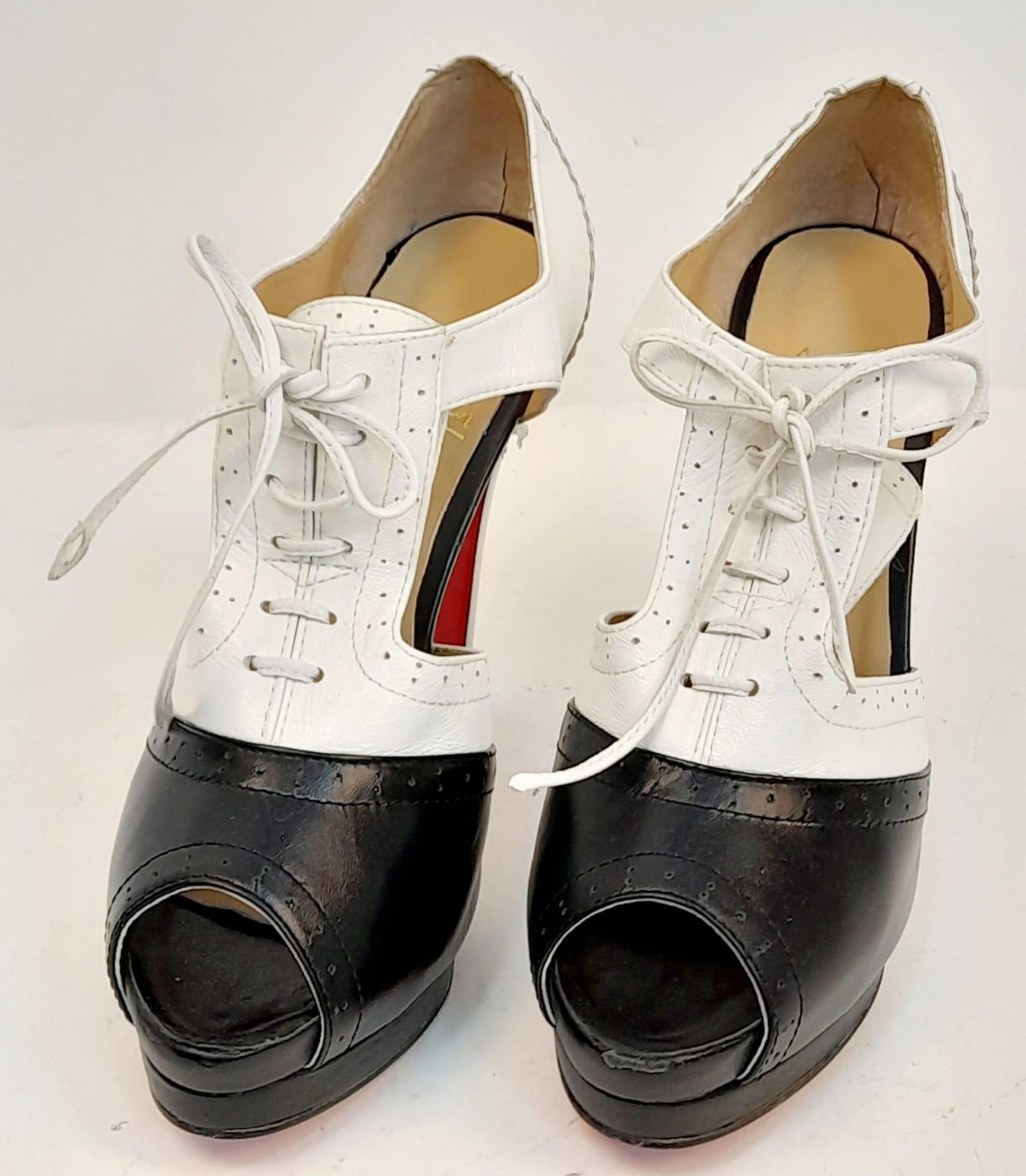 A Pair of Louboutin high heels in black and white leather. Lightly used. Size 40.