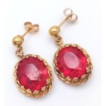 A PAIR OF FABULOUS 14K GOLD AND RUBY EARRINGS . 4.6gms