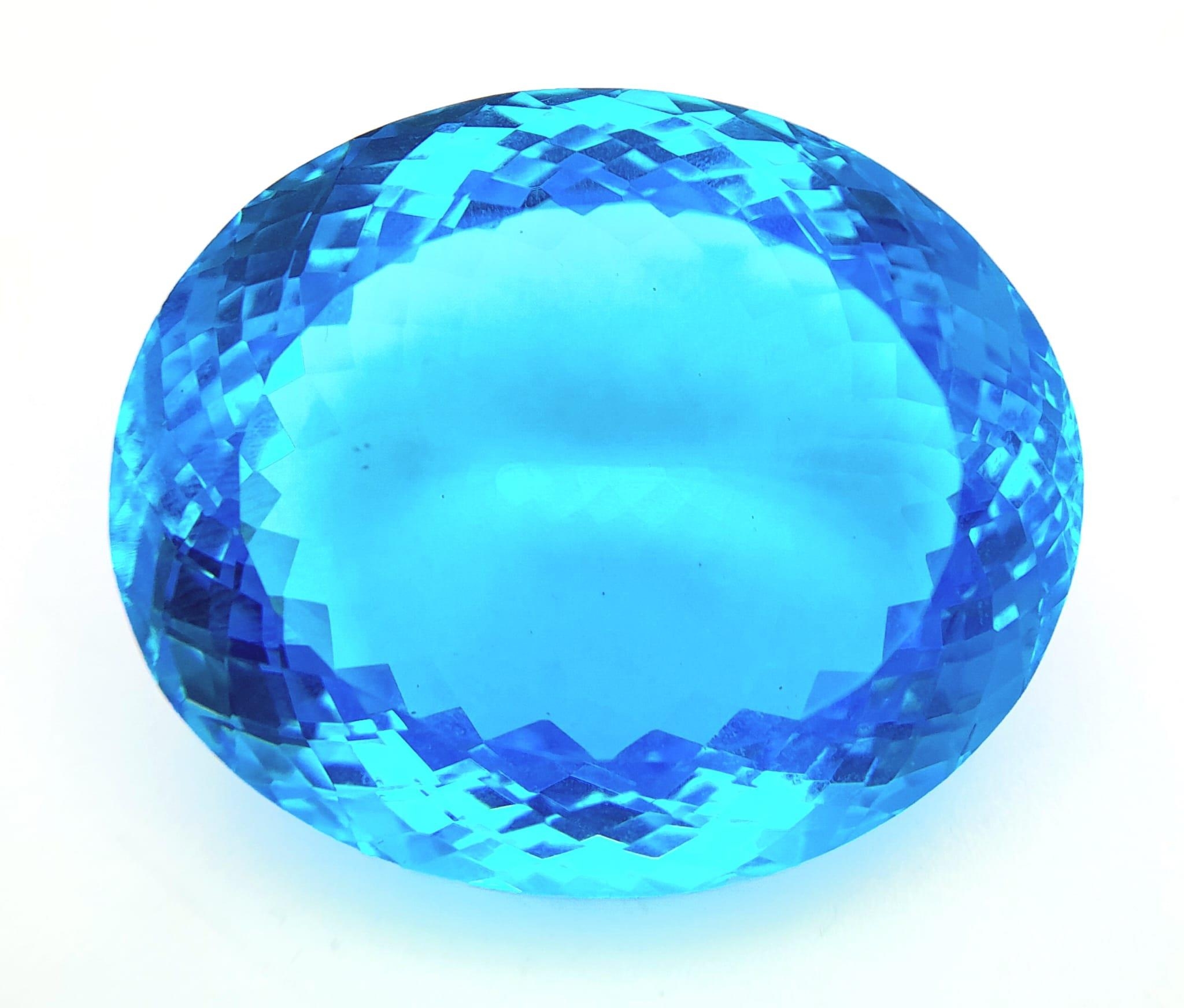 A large (162.81 carats), oval cut natural topaz, with vivid sky blue uniform colouration,