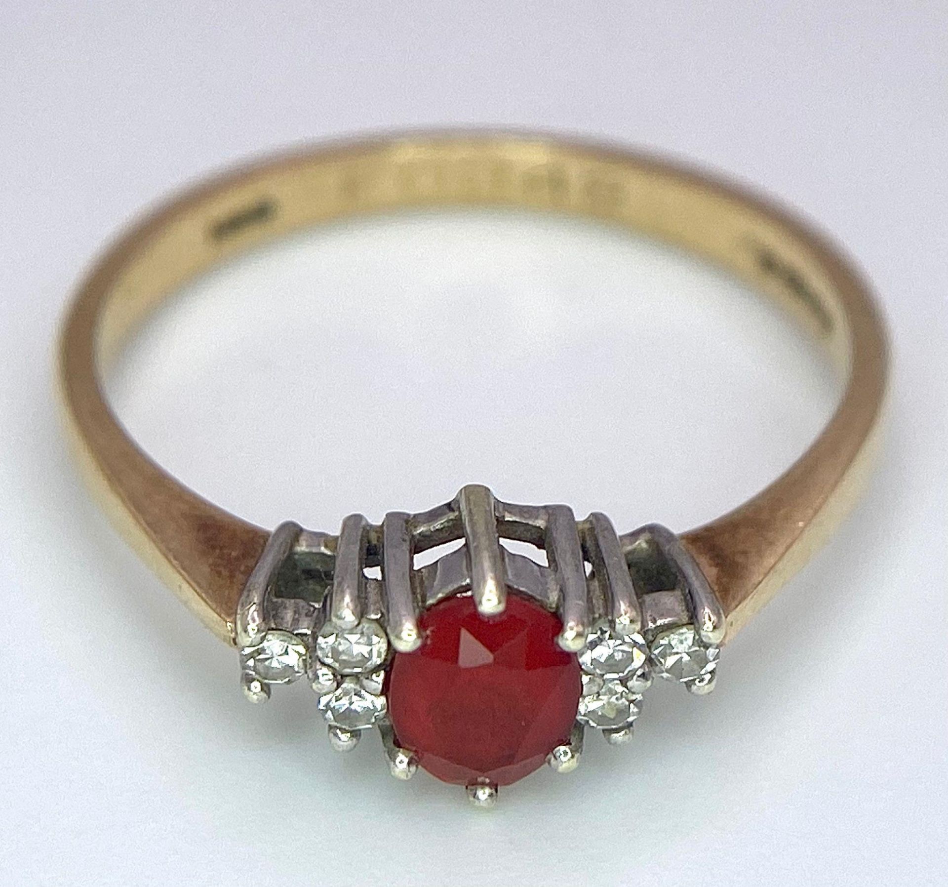 A Vintage 9K Yellow Gold, Red Sapphire and Diamond Ring. Oval sapphire with diamond accents. Size O. - Image 4 of 8