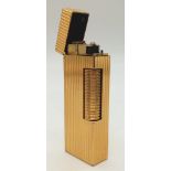 A vintage, gold plated DUNHILL lighter, hight: 6. 4 cm, weight: 76 g. UK Mainland Sales Only.