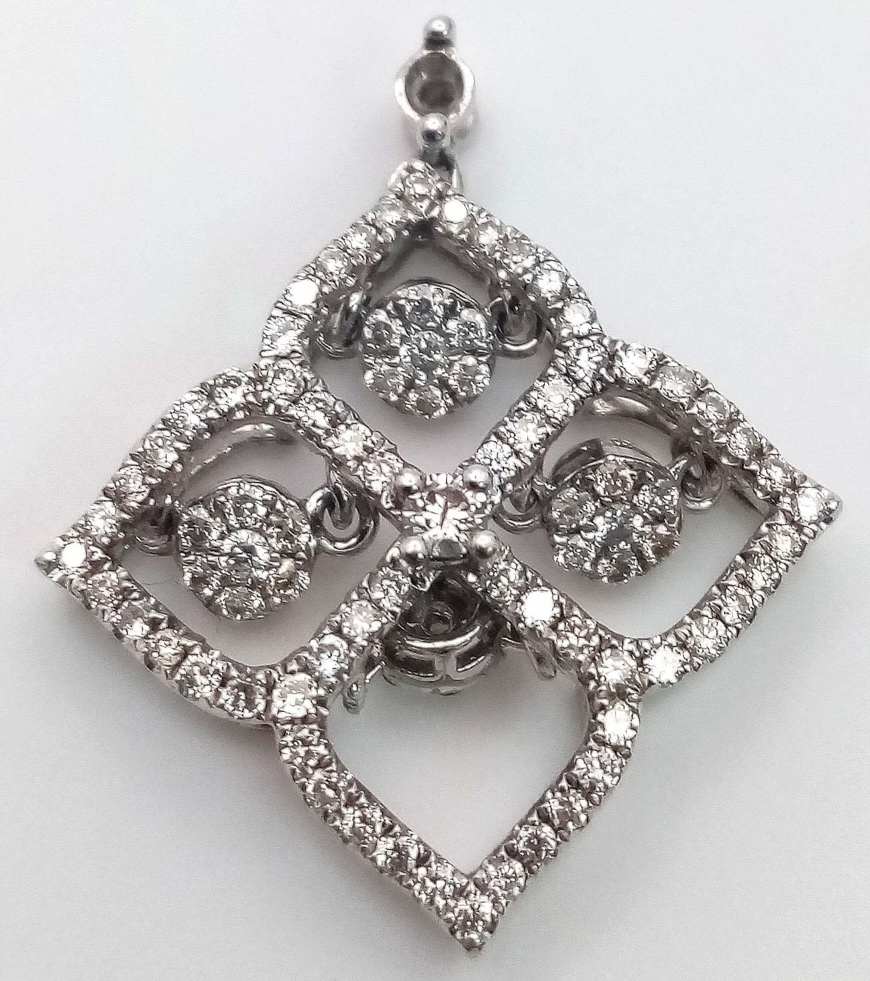 A 9 K white gold four sector pendant with diamonds and moving diamonds in each sector. Dimensions: - Image 3 of 6