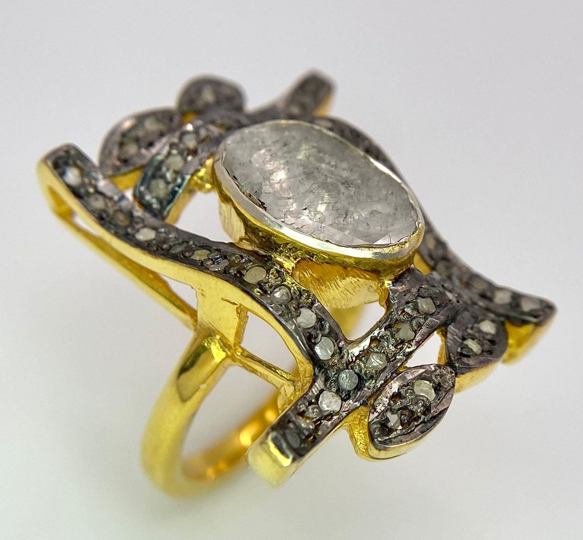 A spectacular, antique silver and gold ring with a large natural, old cut diamond (2.80 carats