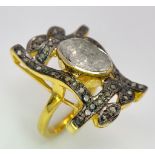 A spectacular, antique silver and gold ring with a large natural, old cut diamond (2.80 carats