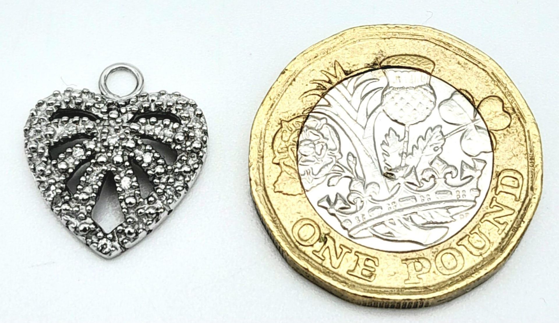A 9K White Gold Diamond Set Heart Pendant/Charm. 1.7cm length, 1.3g total weight. Ref: 8413 - Image 4 of 7