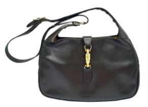 A Gucci Brown Jackie Bag. Leather exterior with gold-toned hardware, adjustable strap and push