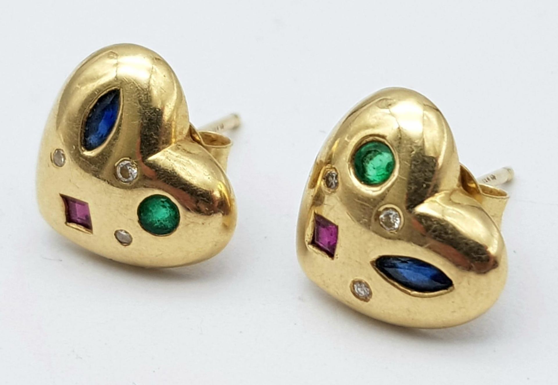 A 9 K yellow gold, heart shaped earrings with emeralds, sapphires, rubies and diamonds.