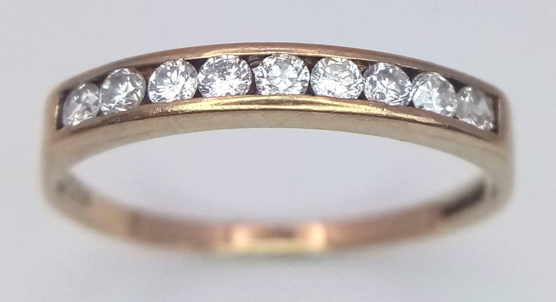 A 9K Yellow Gold Diamond Half Eternity Ring. 0.25ctw, Size P, 1.2g total weight. Ref: SC 7063