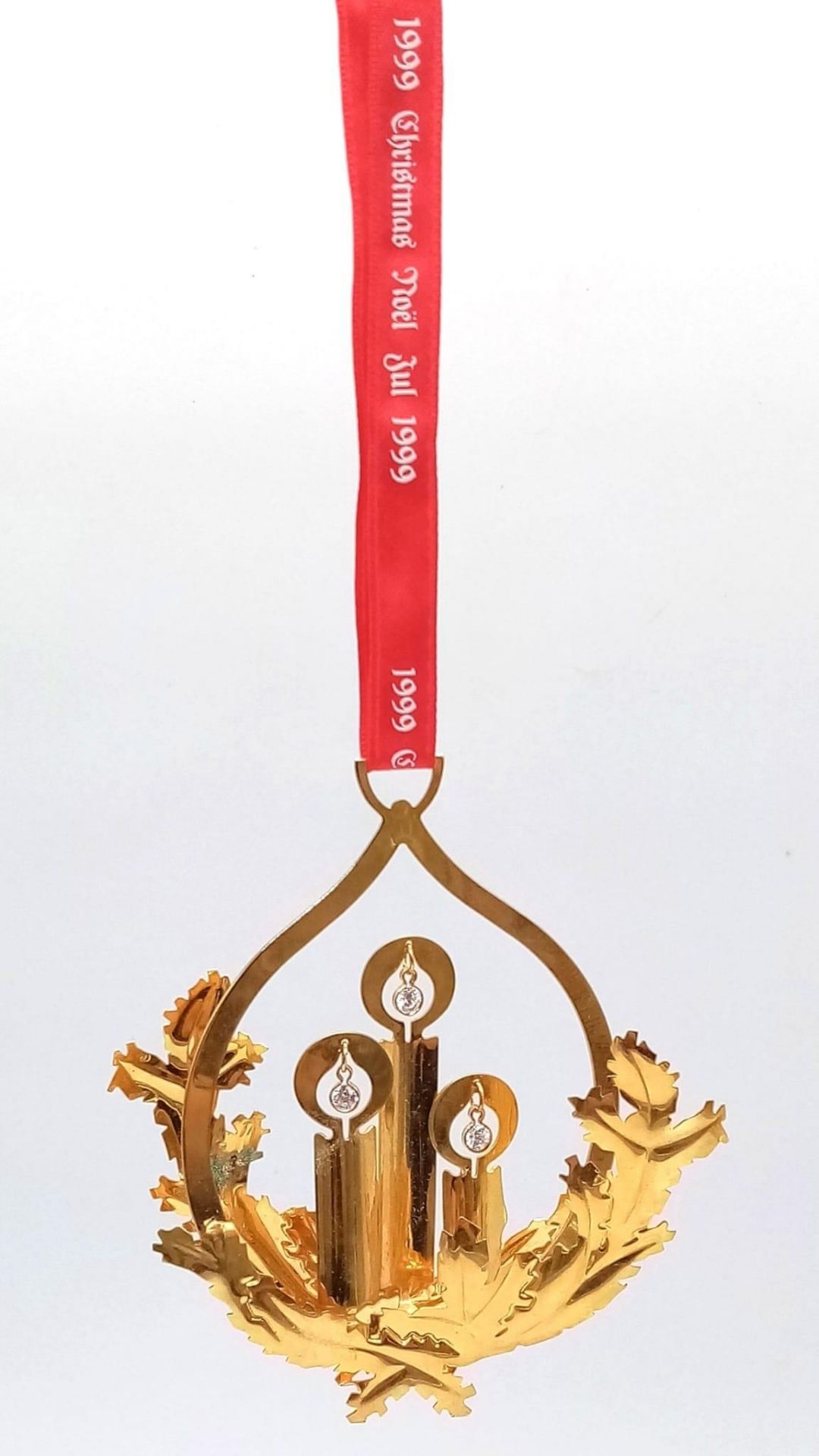 A Georg Jensen Gilded Christmas Ornament. 9cm x 12cm. On a hanging red ribbon. Comes in original