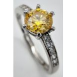A 1ct Golden Yellow Moissanite Ring set in 925 Silver. Size O. Comes with a GRA certificate.