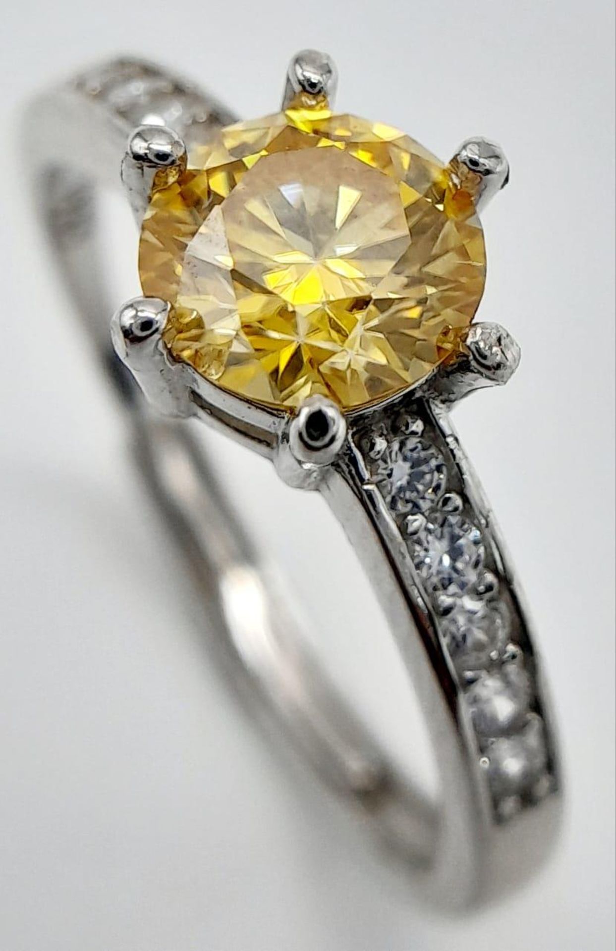 A 1ct Golden Yellow Moissanite Ring set in 925 Silver. Size O. Comes with a GRA certificate.