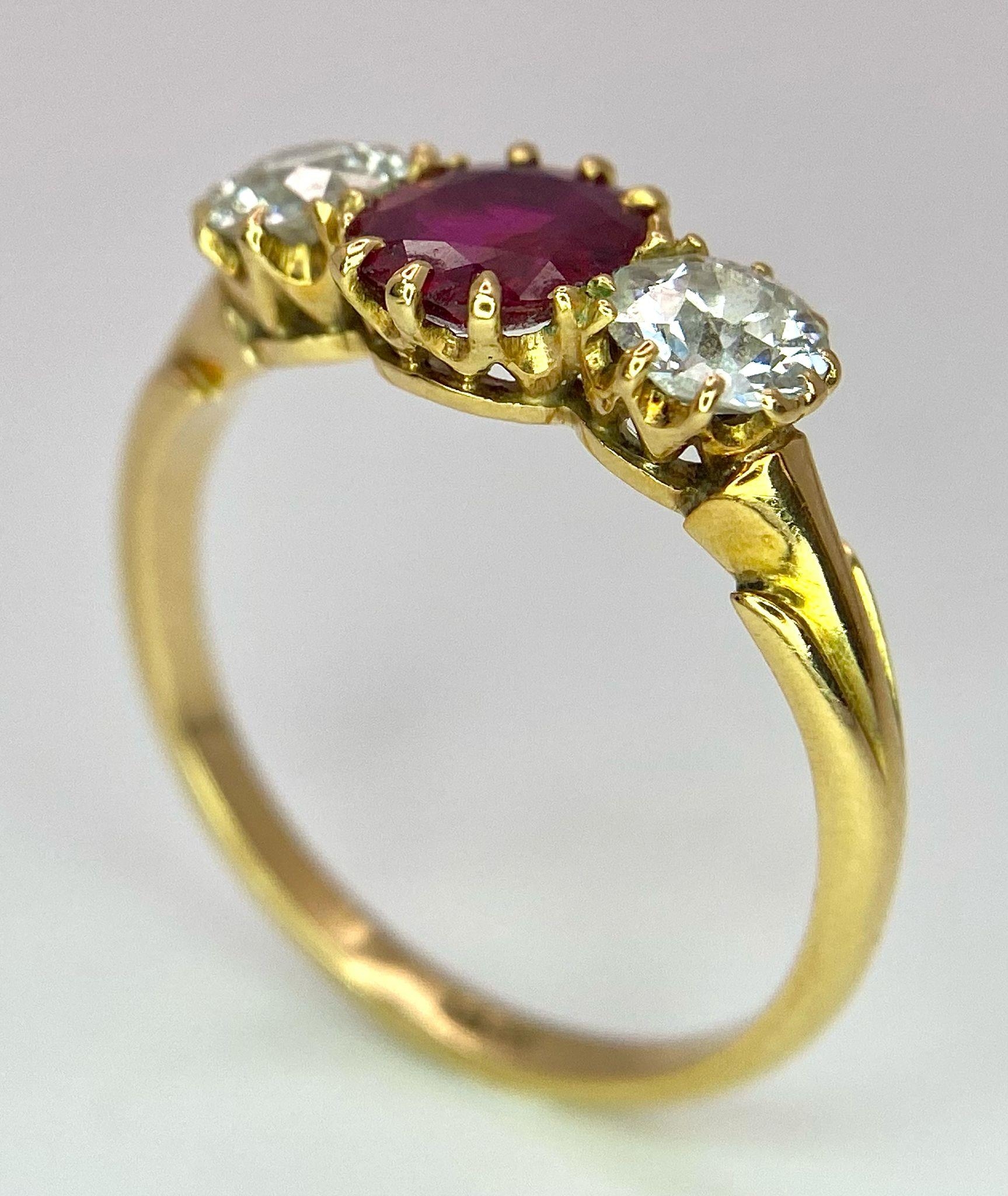 A Mesmerising 18K Yellow Gold, Ruby and Diamond Ring. A deep red oval cut ruby sits central - Image 5 of 9