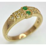 A 9K Yellow Gold Emerald and Diamond Ring. Two emeralds with diamond accents. Size N. 3.65g