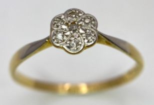 An 18K Yellow Gold, Platinum Diamond Ring. Size Q. Seven old cut diamonds in a decorative floral