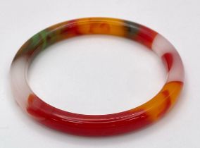 A Swirling Multi-Coloured Decorative Thin Jade Bangle. 6cm inner diameter.