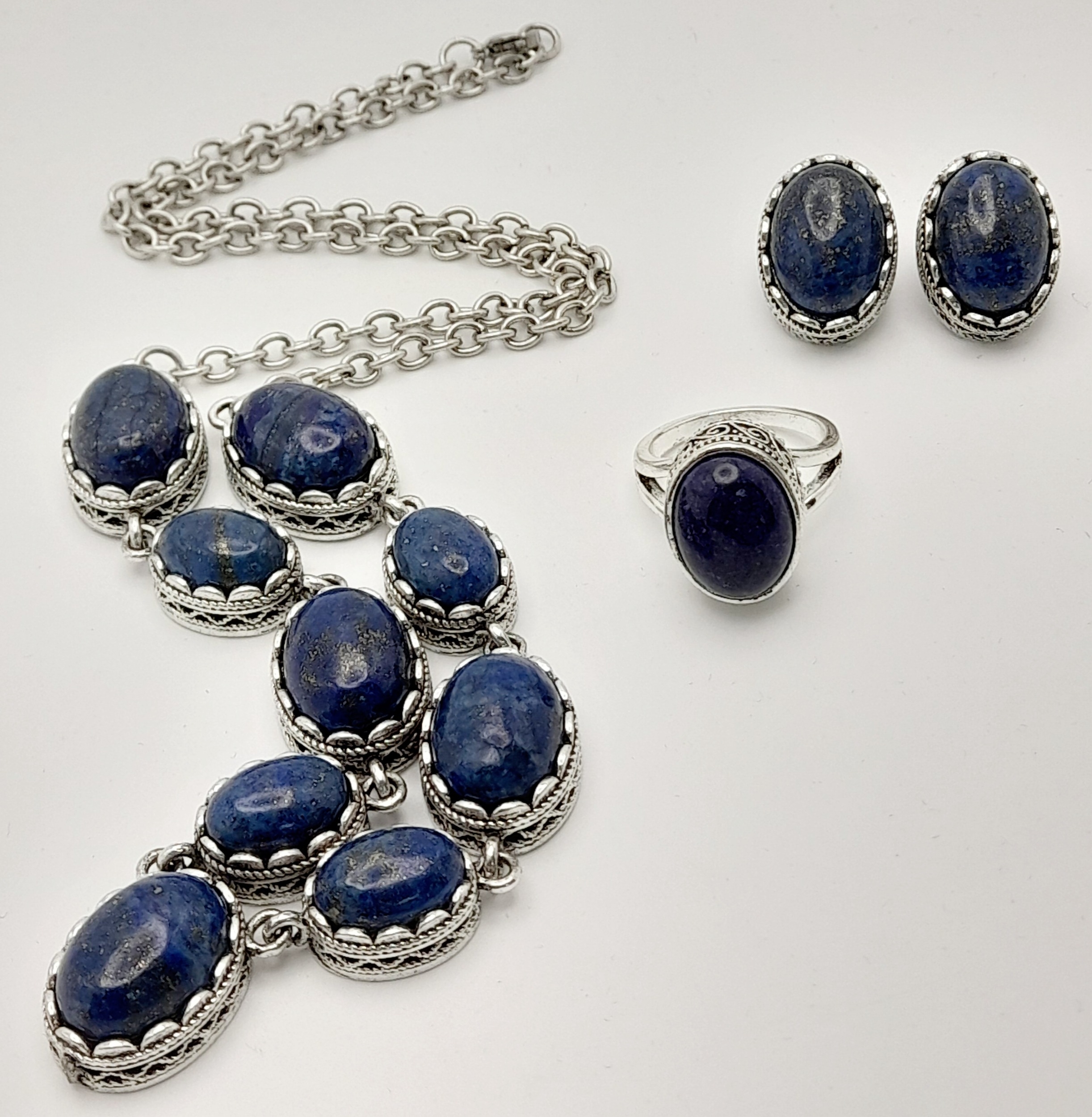A Lapis Lazuli Jewellery Suite. Cabochon necklace, earrings and ring - size R.
