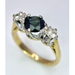 An 18K White Gold, Diamond and Sapphire Ring. Central round cut sapphire with a diamond either side.