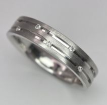 An 18K White Gold Two-Row Diamond Eternity Ring. Size O. 4.9g total weight.