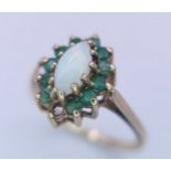 A 9K YELLOW GOLD OPAL & EMERALD CLUSTER RING. (1 stone missing) Size M, 2.5g total weight. Ref: SC
