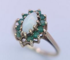A 9K YELLOW GOLD OPAL & EMERALD CLUSTER RING. (1 stone missing) Size M, 2.5g total weight. Ref: SC