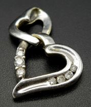 A 9K WHITE GOLD DIAMOND SET DOUBLE HEART PENDANT. 2cm length, 1.6g total weight. Ref: SC 8035