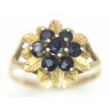 A 9 K yellow gold ring with a cluster of round cut sapphires, size: M1/2, weight: 1.7 g.