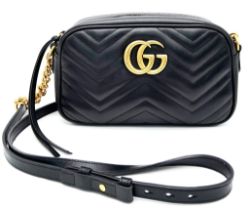 A Gucci Marmont Quilted Leather Cross-Body bag. Adjustable shoulder strap. Gold-tone Hardware. Beige
