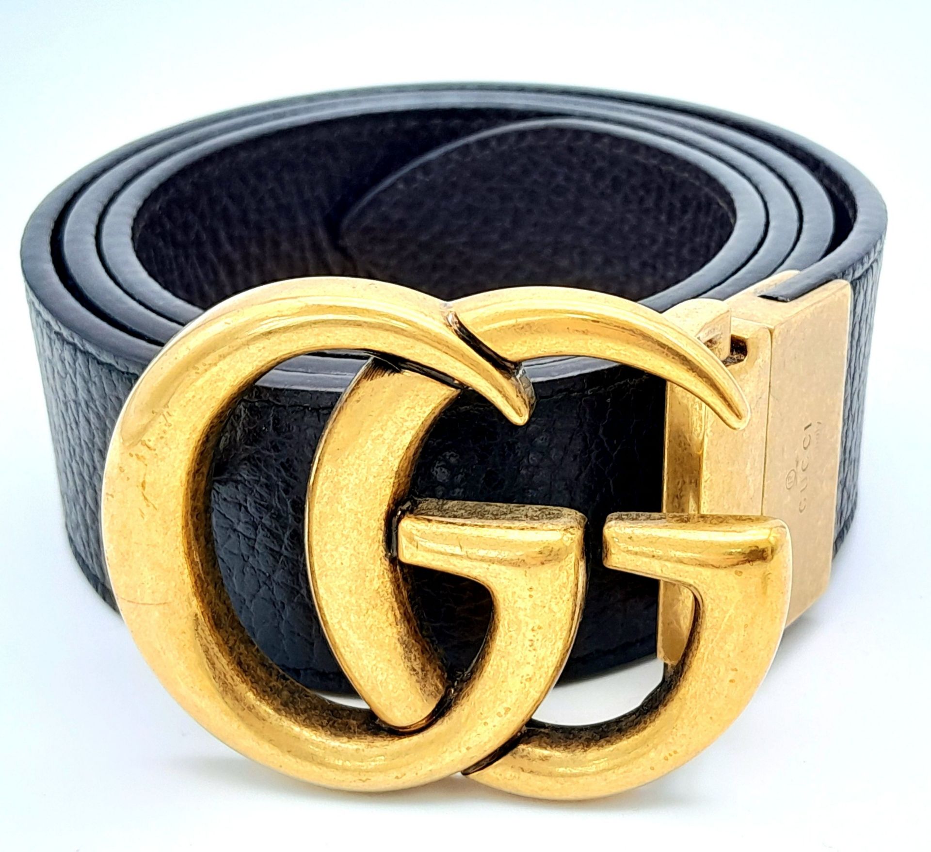A Gucci Black Leather Belt. Classic gold tone Gucci monogram buckle. 94cm. Ref: 015222