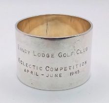 A vintage sterling silver circular napkin holder presenting the Eclectic Competition of Sandy