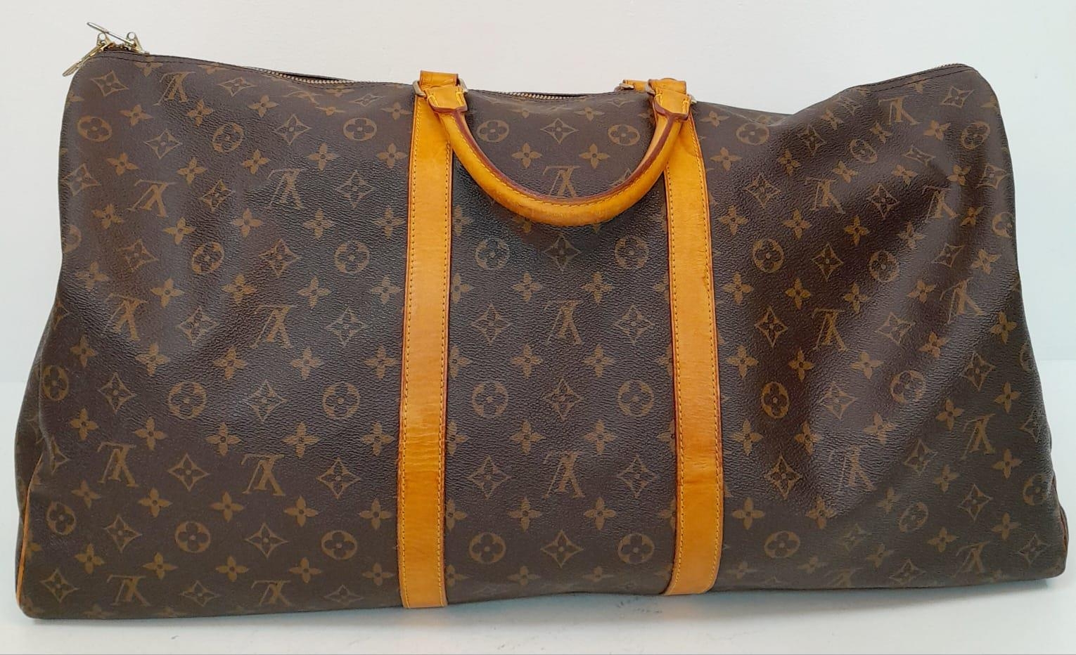 A Large Louis Vuitton Keepall Travel Bag. Monogram LV canvas exterior with cowhide leather handles - Image 2 of 8