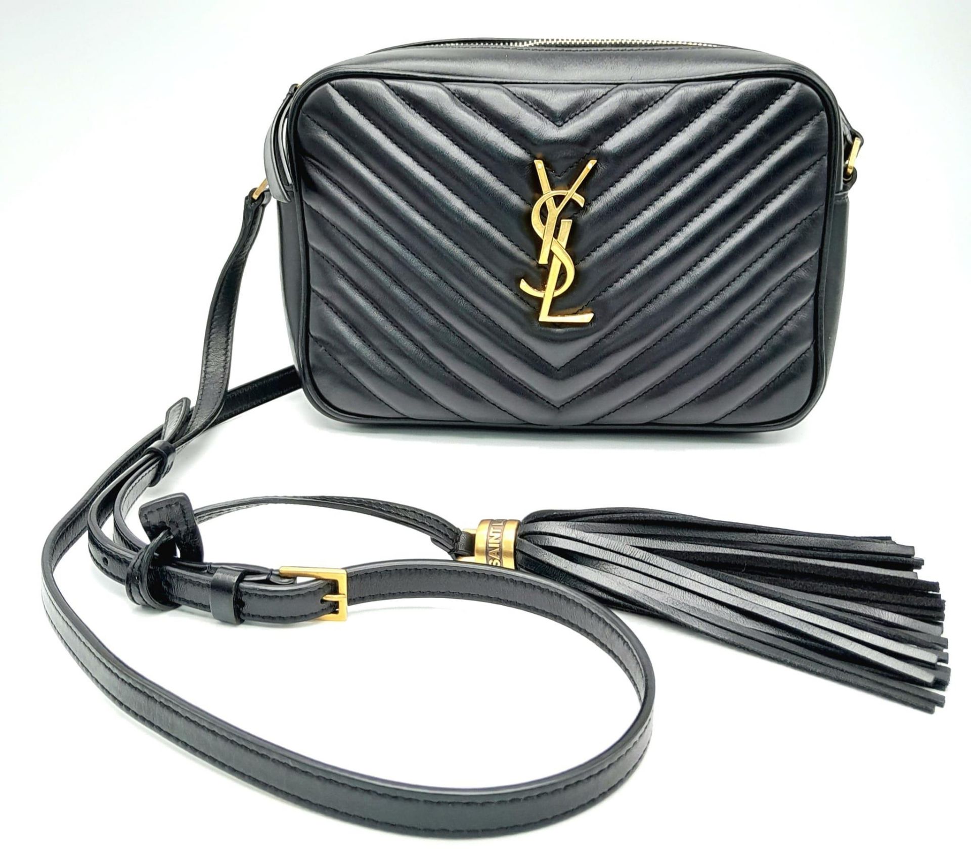 A YSL Saint Laurent Black Lou Matelasse Camera Bag. Leather exterior, gold-tone hardware, adjustable