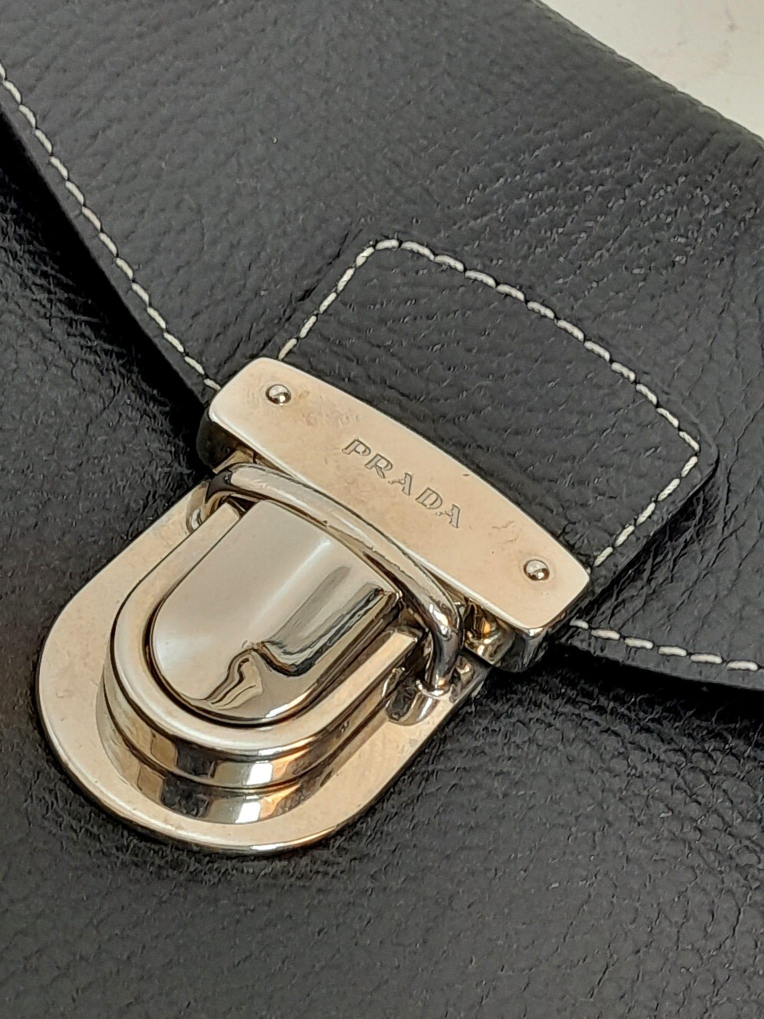 A Prada Black Shoulder Bag. Leather exterior with silver-toned hardware, two rolled leather - Image 4 of 7