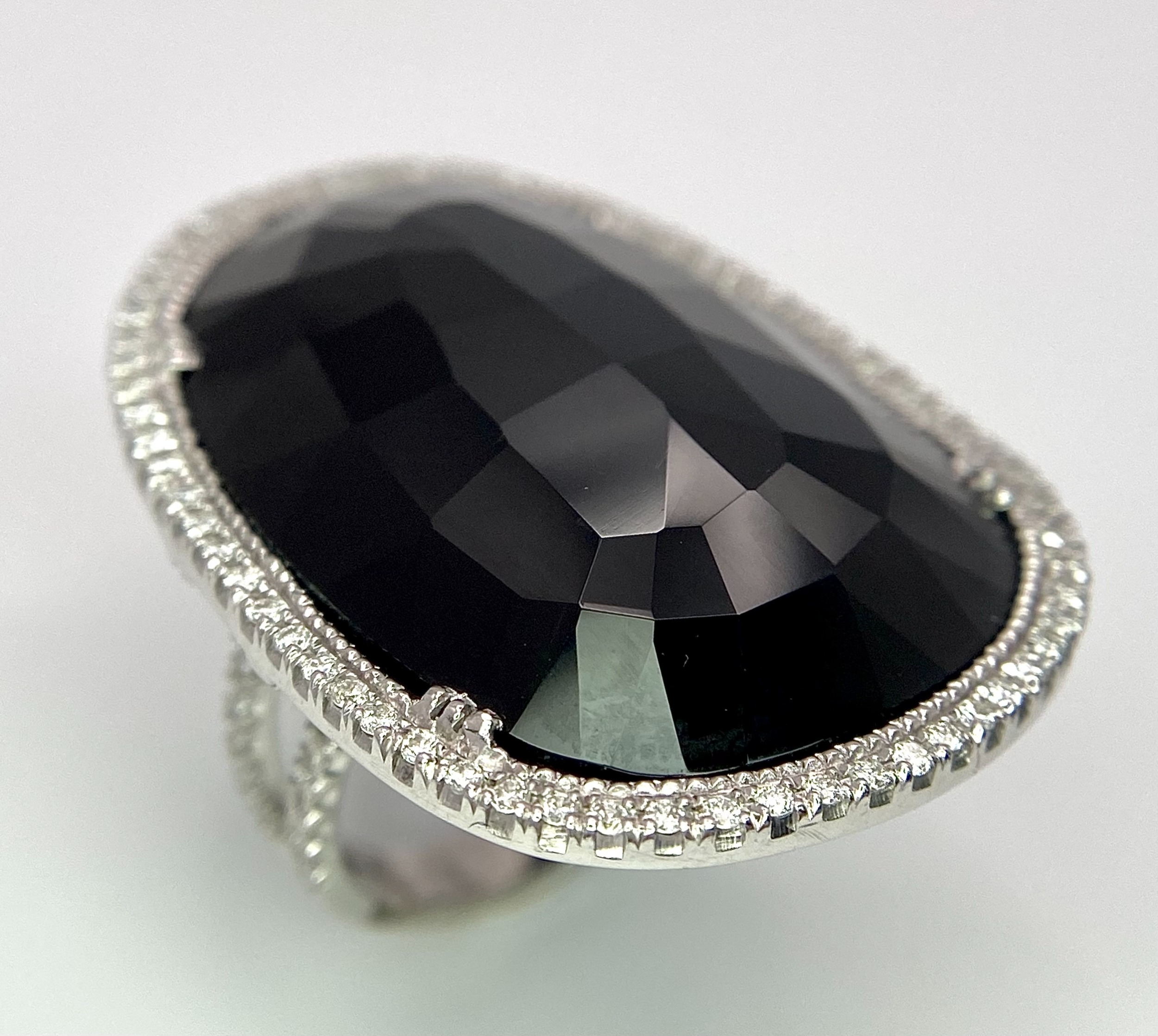 A Beautiful 18k White Gold Black Onyx and Diamond Ladies Dress Ring. Faceted black onyx with a