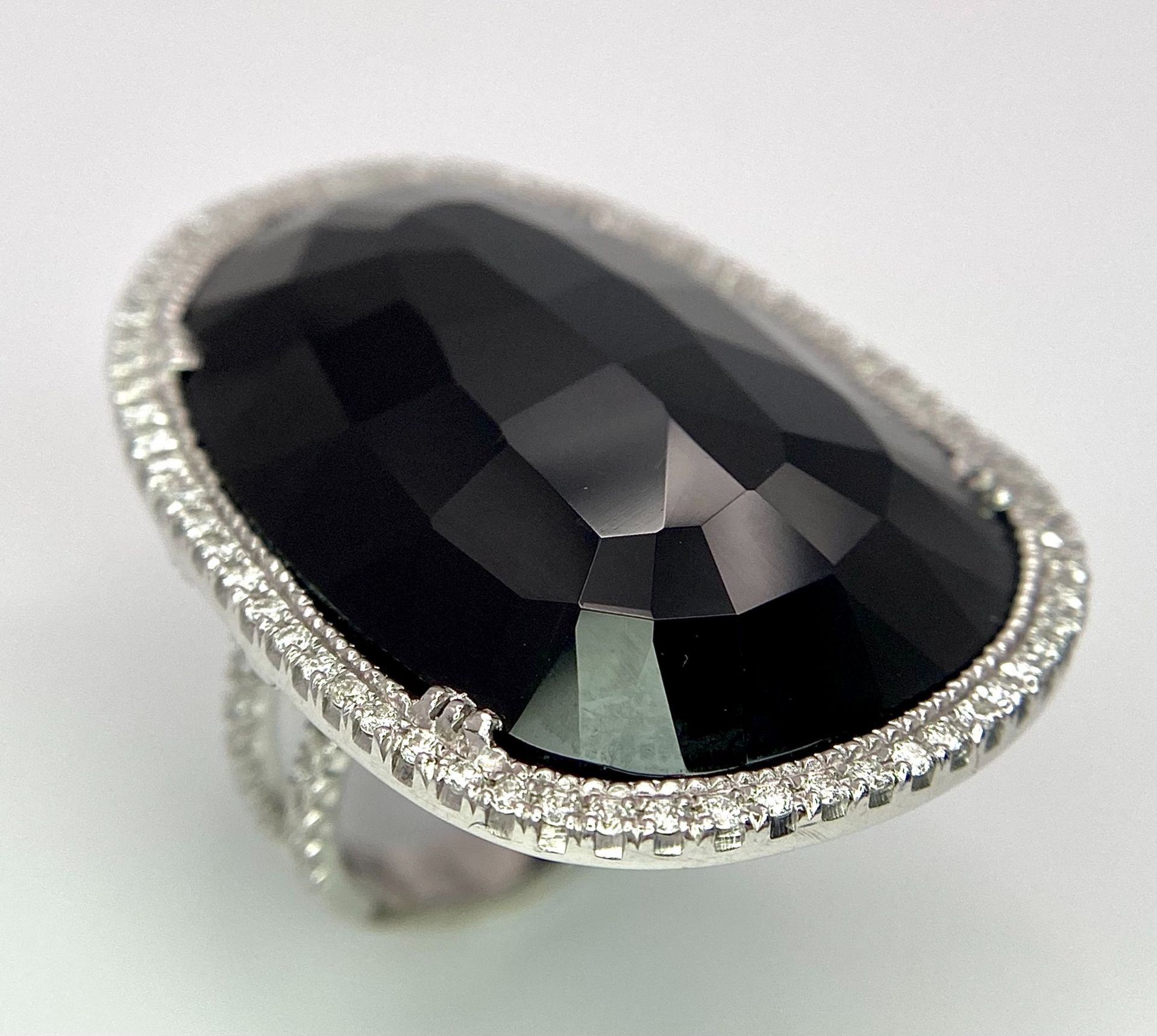 A Beautiful 18k White Gold Black Onyx and Diamond Ladies Dress Ring. Faceted black onyx with a