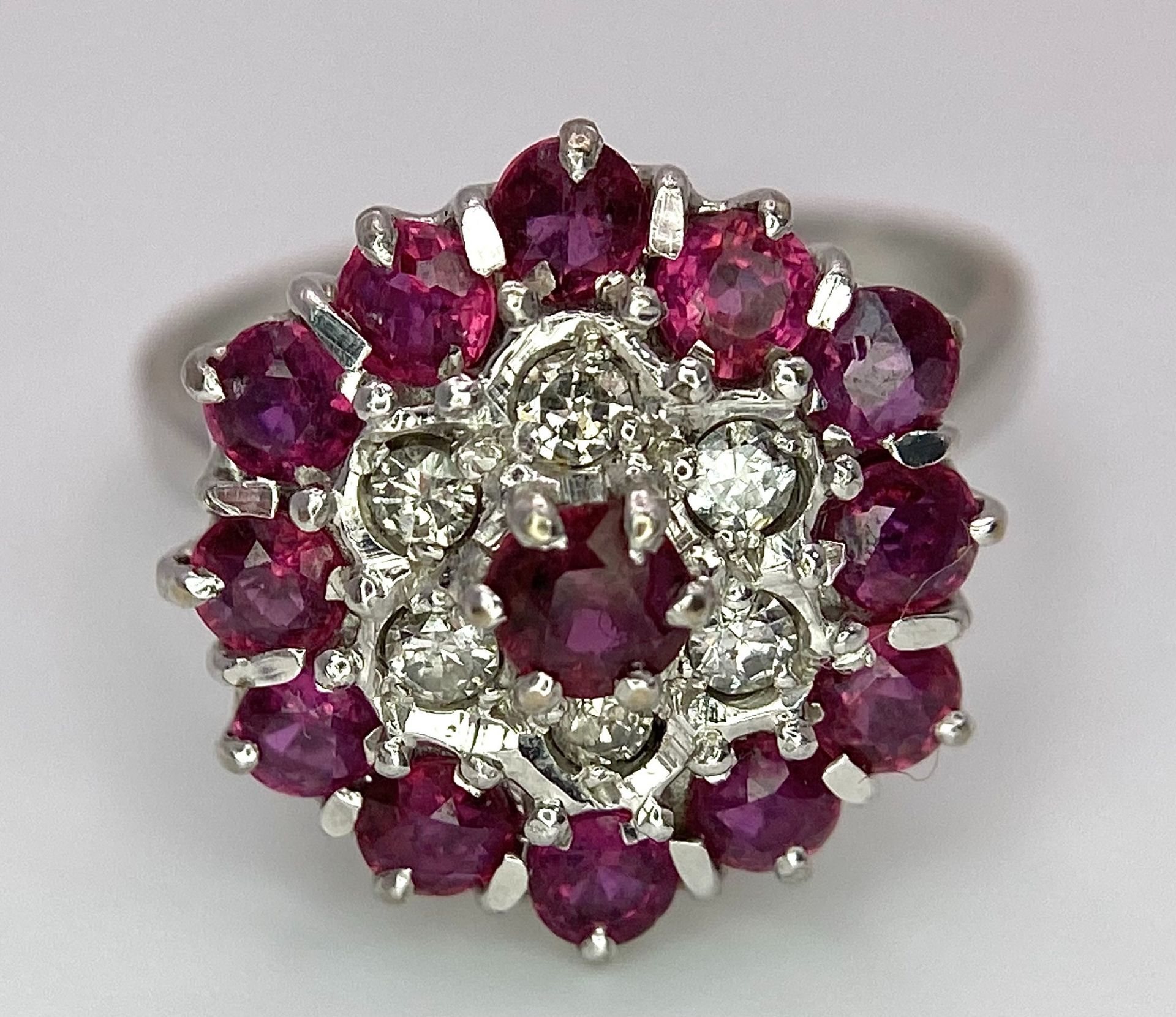 A Gorgeous 18K White Gold, Ruby and Diamond Ring. Floral design on an elevated setting. 14 rubies - Image 5 of 6