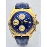 An 18K Gold Breitling Chronograph Gents Watch. Breitling blue leather strap with 18k gold clasp. 18k