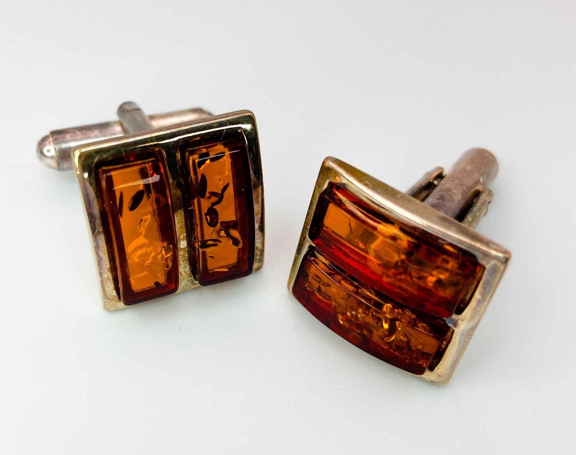 A Pair of Amber and Silver Cufflinks. In original box with certificate. Ref: 016736