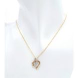 A 9 K yellow gold chain necklace with a heart pendant beautifully crossed over with a band of