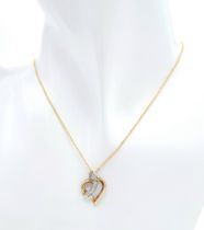 A 9 K yellow gold chain necklace with a heart pendant beautifully crossed over with a band of