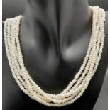 A vintage, five row, natural, white pearl necklace, with a statement gold plated clasp. Length: 42