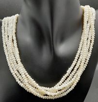 A vintage, five row, natural, white pearl necklace, with a statement gold plated clasp. Length: 42