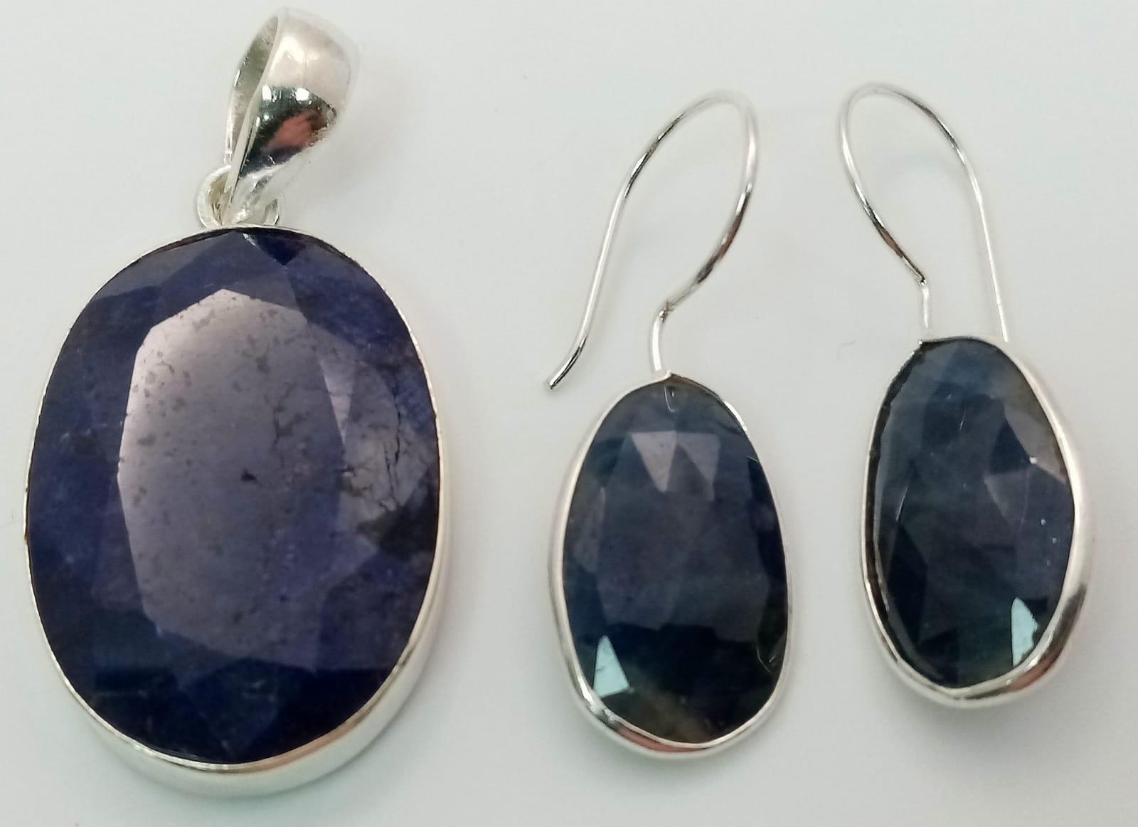 A Blue Sapphire Pendant with Matching Earrings - Both set in 925 Silver. 4cm and 3.5cm.