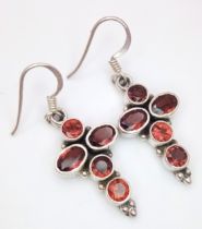 A Pair of Sterling Silver Garnet Set Cross Earrings. 3.5cm drop. 1.4cm Wide and set with 5 Round and