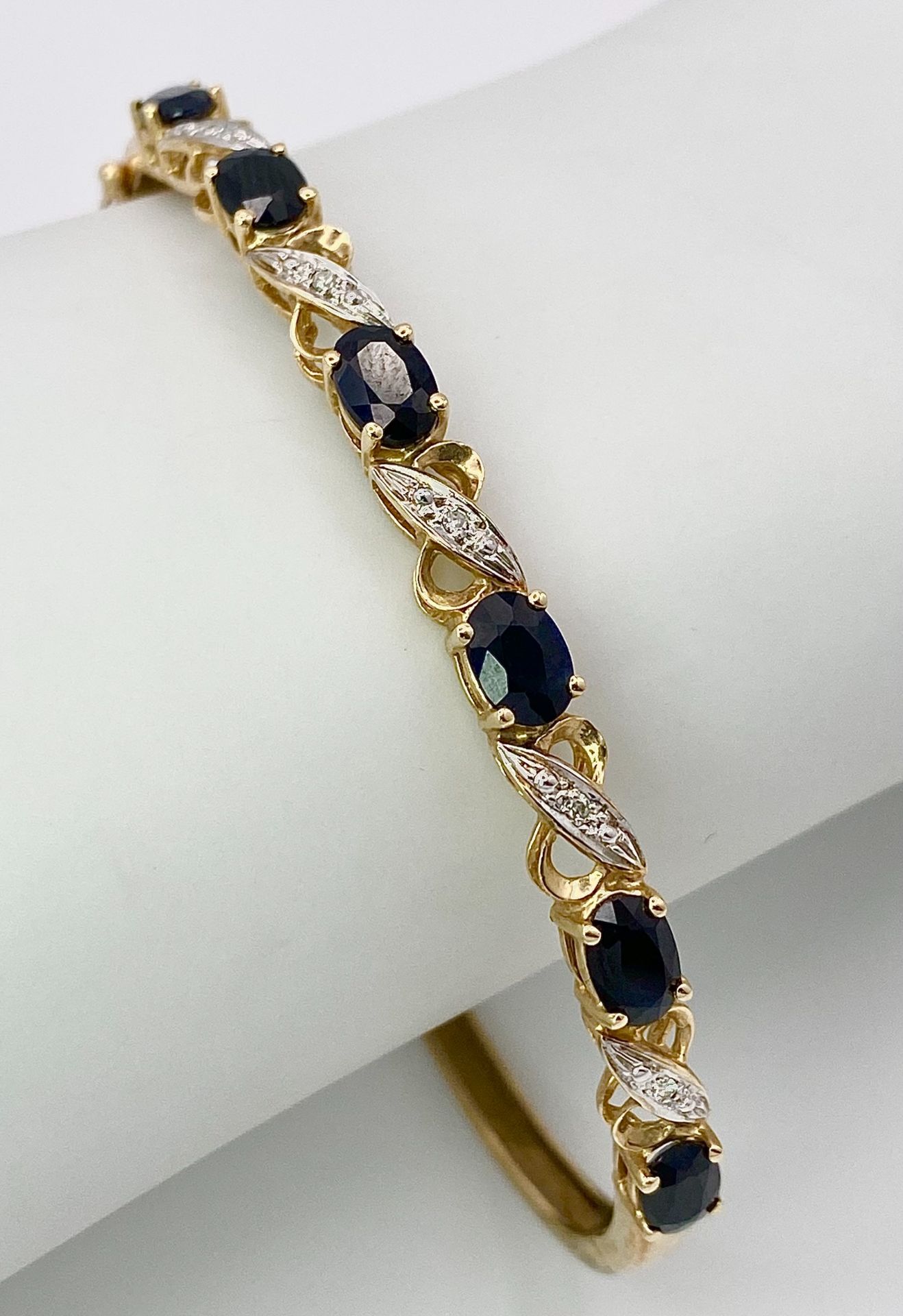 A Vintage 9K Yellow Gold Sapphire and Diamond Bangle. Six oval cut sapphires with diagonal - Image 6 of 6