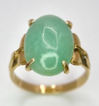 A 9K Yellow Gold Jade Cabochon Ring. 1.8cm jade. Size L, 3.1g total weight.