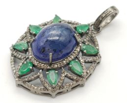 An 11.3ct Tanzanite, Emerald and Diamond Pendant. Central tanzanite cabochon with emerald surround