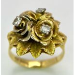 An 18K Yellow Gold and Diamond Floral Design Ring. A rich cluster of golden petals give sanctuary to
