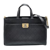 A Chanel black quilted caviar leather straight line tote bag. Silver and gold tone hardware, studded
